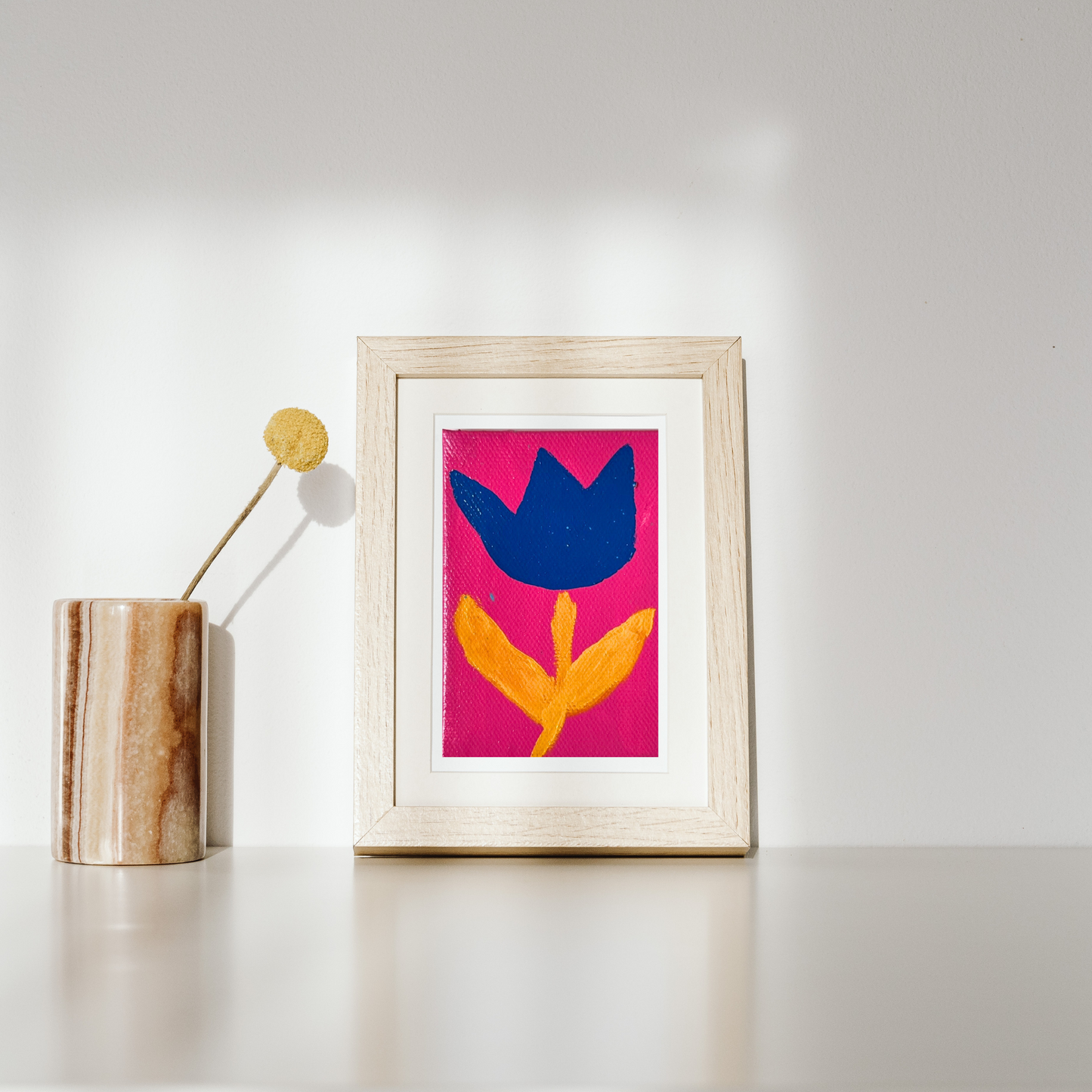 A modern tulip on canvas in vivid cobalt and golden tones against a bright background.